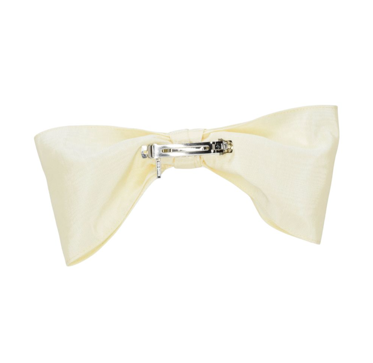 Cream-colored bow hair clip on a white background