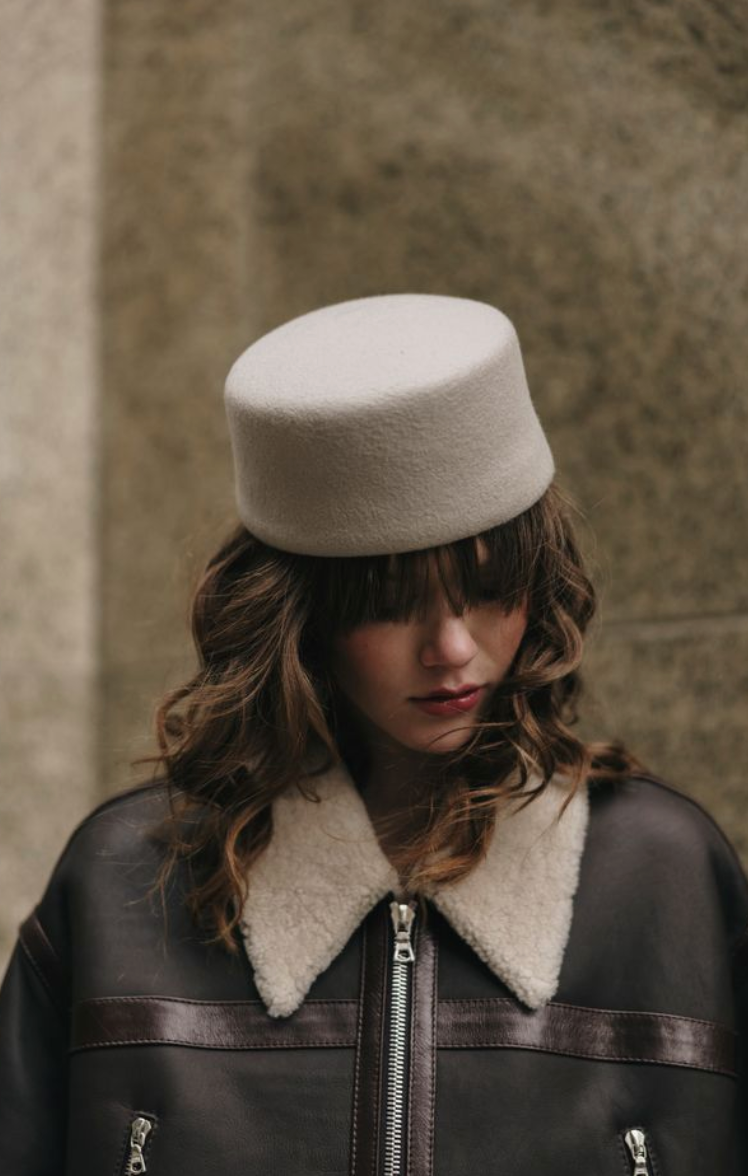 Person wearing a beige hat