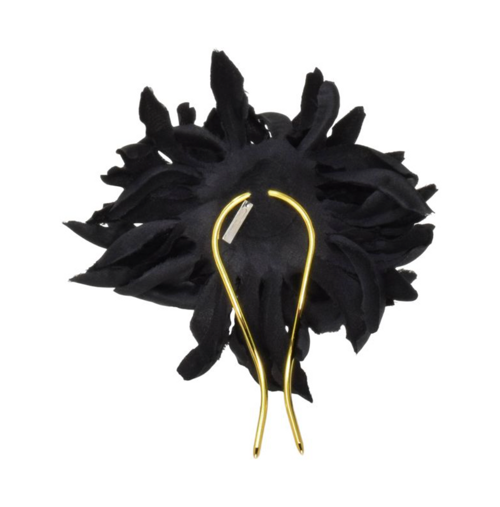 Black feathered headpiece with gold hairpins on a white background
