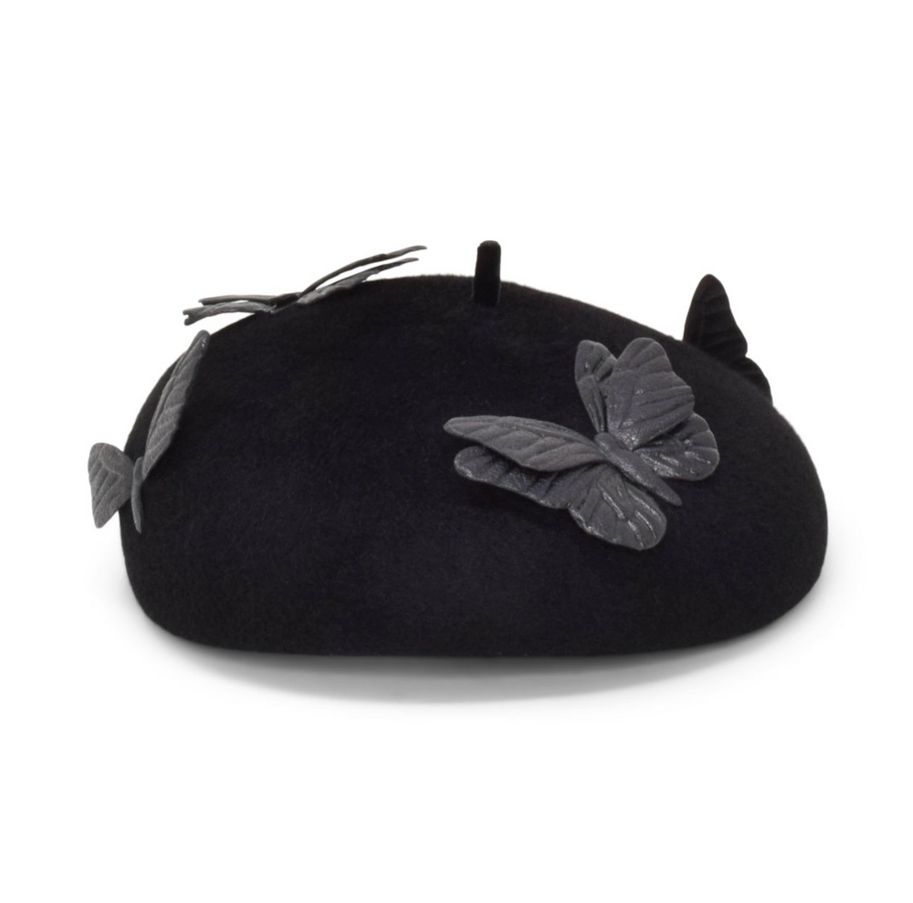 Black beret with butterfly and leaf decorations on a white background