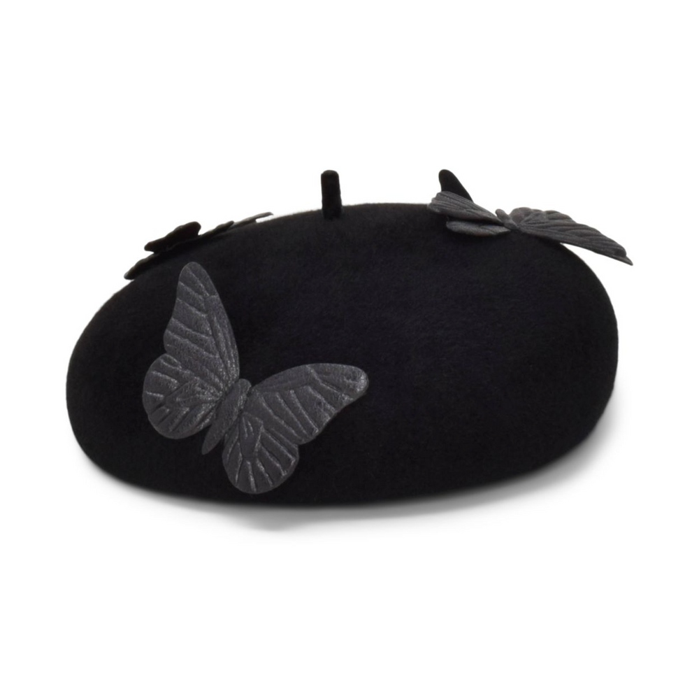 Black beret with butterfly and leaf decorations on a white background