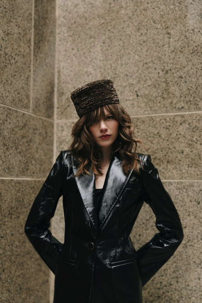 Person wearing textured brown hat 