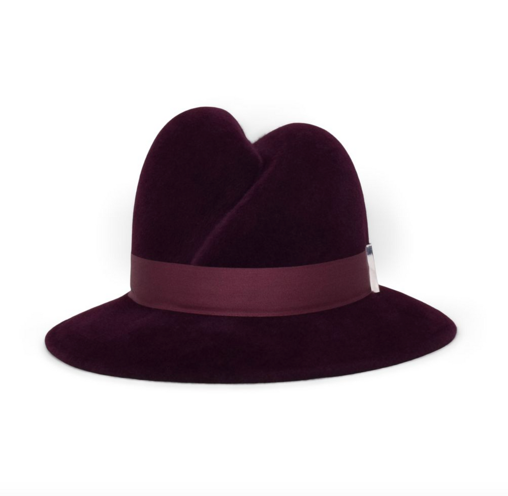 Purple fedora hat with a wide brim on a white background